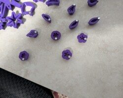 Tiny magnets glued to the pushing edge of tiny cutters